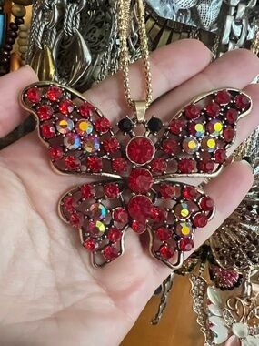 Butterfly necklace. Gold tone chain. Red rhinestones . Lobster clasp